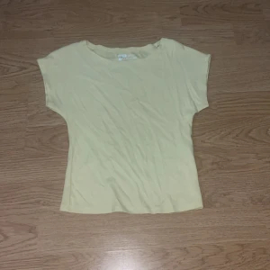 Ljusgul croppad topp från FB Sister - Säljer en ljusgul croppad topp från FB Sister i slim fit-modell. Toppen är ärmlös med rund halsringning och tillverkad i mjuk bomull. Perfekt för dig som gillar en enkel och fräsch stil.
