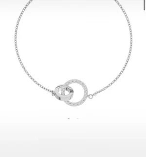 Silverarmband med cirkelberlocker - Stilrent armband i silver med två sammanlänkade cirkelberlocker, varav en är dekorerad med små gnistrande stenar. Kedjan är tunn och elegant, perfekt för dig som gillar minimalistisk design med en touch av bling.