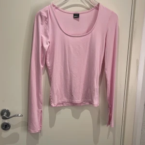 Ljusrosa långärmad topp Gina Tricot - Säljer en ljusrosa långärmad topp från Gina Tricot i storlek S. Toppen har en rundad halsringning och är gjord i mjukt, stretchigt material som sitter snyggt mot kroppen. Perfekt att styla med jeans eller kjol för en fräsch look.