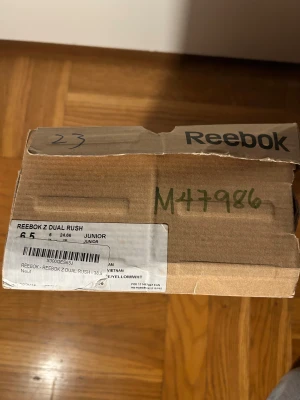 Reebok Z Dual Rush sneakers rosa/turkos - Säljer ett par Reebok Z Dual Rush sneakers i juniorstorlek 38,5. Skorna har en snygg rosa mesh-överdel med turkosa och gula detaljer, samt vita platta sulor. De har snörning och Reebok-logga på sidan. Perfekta för träning eller sportiga outfits.