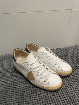 Phillipe models  - Hej! Jag säljer ett par vit-beiga phillipe model skor.🙌Skorna är i fint skick med några yttre skavanker som inte märks av. Skorna är i storlek 39, och är perfekt för dig som gillar en stilren lock! Ta kontakt med mig vid några som helst funderingar eller frågor.🙌💪Pris går att diskutera! MVH, Milo. 