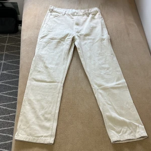 Vita cargopants i bomull - Snygga vita cargopants med raka ben och flera praktiska fickor på sidorna och bak. Byxorna har normal passform och är tillverkade i mjukt bomullstyg, perfekta för en avslappnad och trendig stil. Passar dig som gillar enkel och clean look.