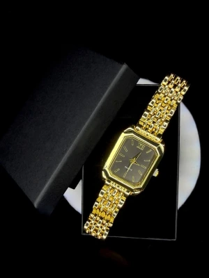 Quartz Black Edition *Helt ny* - Quartz Black Edition, helt ny och oanvänd. Den här modellen har en djup svart urtavla som tillsammans med den guldfärgade rektangulära boetten verkar nästan spegelblank i ljuset. De smala guldfärgade indexen ger ett sobert och modernt uttryck, medan länken tillför en tydlig smyckeskänsla.  Black Edition passar perfekt för dig som vill ha en klocka som känns mystisk, elegant och självsäker, och som sticker ut utan att bli för mycket.