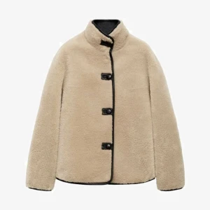 Beige teddyjacka - Mysig beige teddyjacka med hög krage och svarta kantdetaljer. Är från mango och är helt slutsåld överallt, den är helt ny