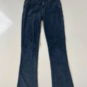 Svarta manchesterbyxor från LTB - Snygga svarta manchesterbyxor från LTB, modell FALLON. Byxorna har klassisk femficksdesign, raka ben och normal passform. Materialet är mjukt och ger en cool vintagekänsla. Perfekta för dig som gillar en stilren look med lite edge.