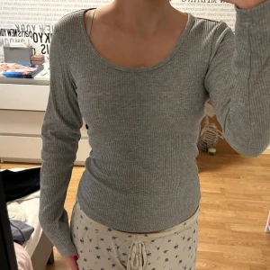Grå ribbad långärmad tröja - Säljer en grå långärmad tröja med ribbad struktur och rundad hals. Materialet är mjukt och stretchigt. Tyvärr så saknar tröjan etikett, så jag vet inte vart den är ifrån eller vilken storlek❤️ den sitter som S