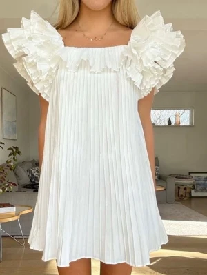 Vit plisserad klänning med volang - Superfin vit kortklänning med plisserat tyg och stora volangdetaljer vid axlarna, från Zara! Så fin till studenten ❤️💓