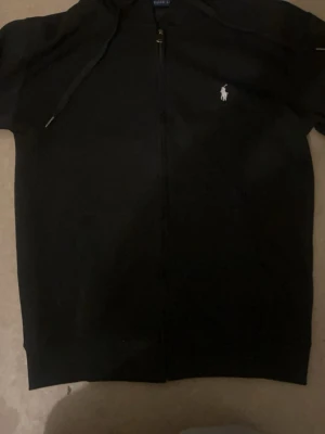 Ralph lauren zip hoodie polo - En stilren och tidlös zip hoodie från Ralph Lauren i klassisk svart färg.
