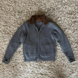 Sothiares päls cardigan - Säljer en grå stickad jacka från Sothiares med en avtagbar mjuk brun fuskpäls på kragen. Jackan har dragkedja framtill och långärmad design. Perfekt för dig som gillar stilrena och mysiga plagg med en twist på kragen. 