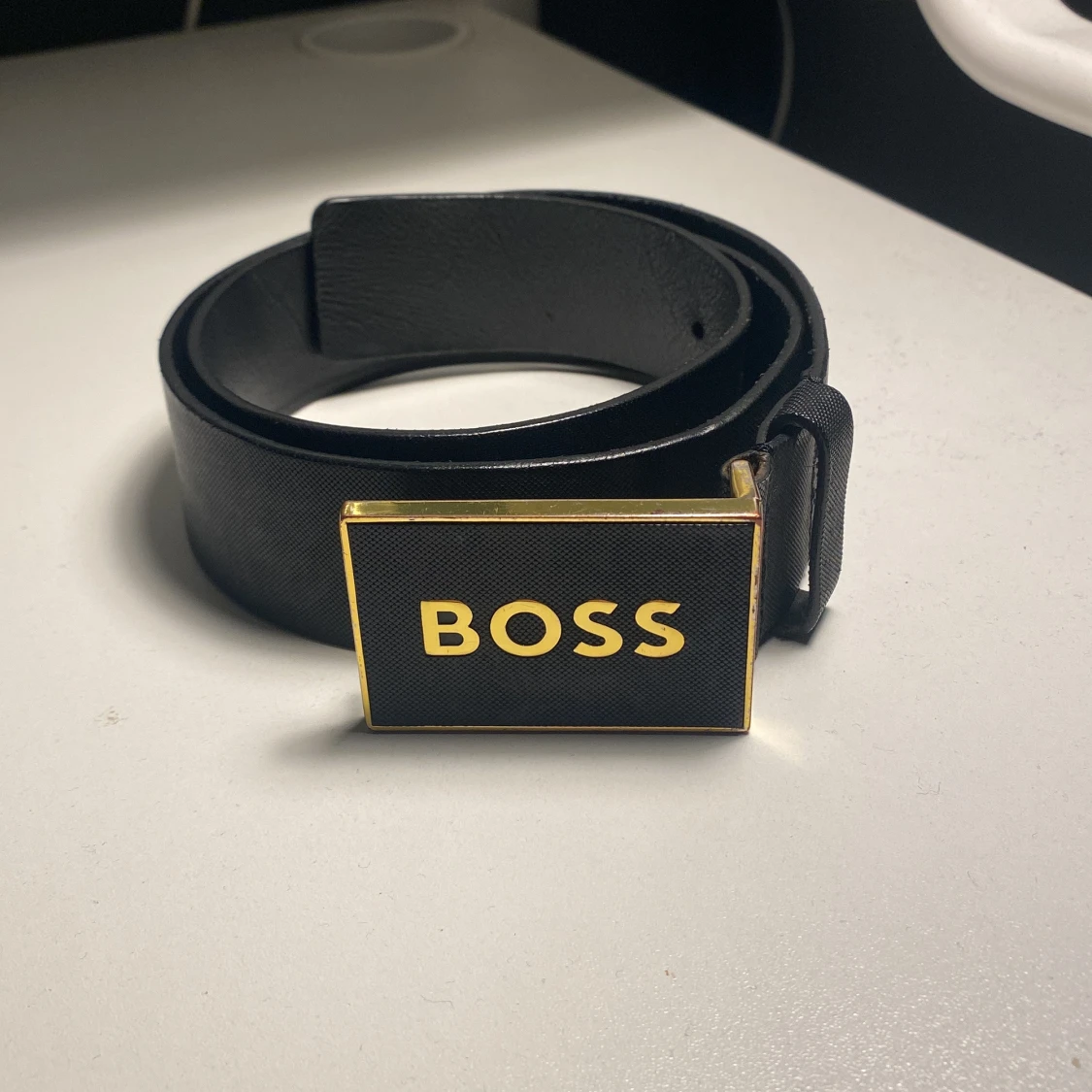 Svart skärp från Hugo Boss med gulddetaljer