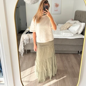 Ljusgrön långkjol  - Superskön ljusgrön långkjol med smock i midjan och volangdetaljer.  Den är så så fin och sitter perfekt efter kroppen! Kjolen är ifrån Gina tricot och är köpt denna sommaren men endast blivit använd vitt ett tillfälle så den är helt som ny!