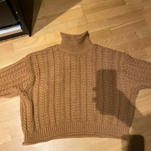 Brun polotröja med flätstickat mönster - Stickad tröja