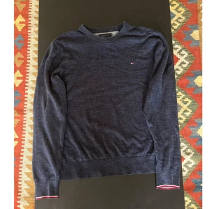 Stickad tröja  - Blå stickad tröja i storlek XL. Tröjan är från Tommy Hilfiger och är i fint skick!