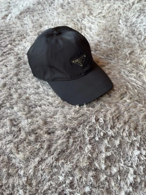 Svart Prada keps - Svart Prada keps | Äkta köpt i Prada butik i Köpenhamn | No size (justerbar) | Mycket Bra skick | Inget Og ingår |