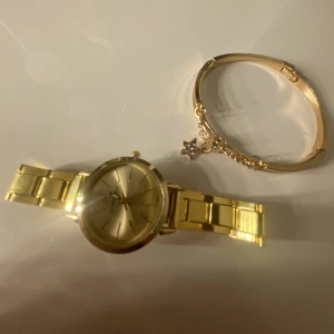 Smycke - En fin klocka med ett smycke till. Båda tillhör varandra. Matchar jätre bra till outfits. Inte använt en ända gång . Kom dm för fler bilder 💞