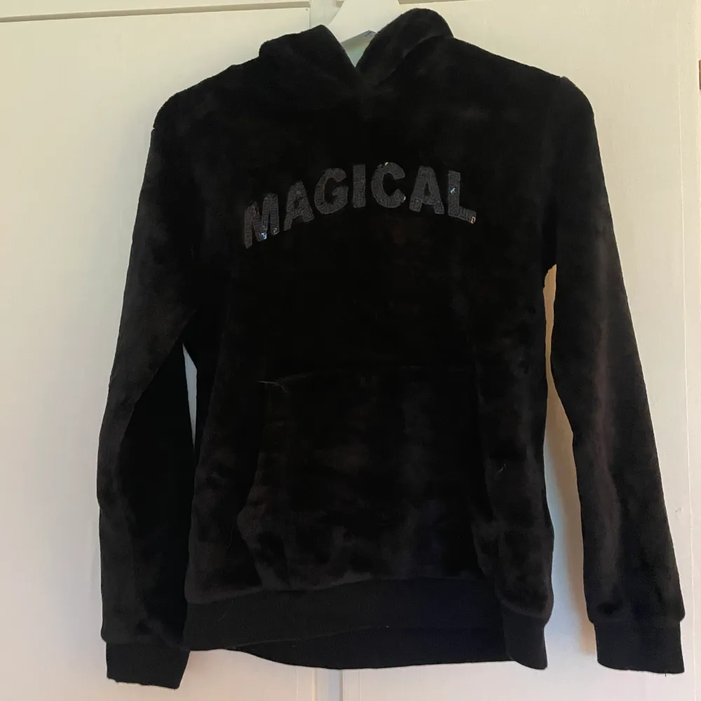 En svart hoodie från antingen newyorker eller h&m! Det står ”magical” och är en katt på luvan. Hoodies.