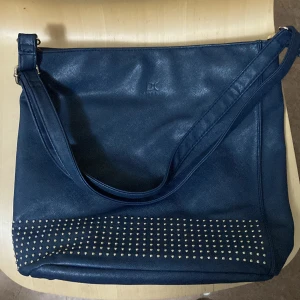 Purse - Large purse. Can take a laptop + books + more. Changeable strap size. Smaller sections inside. 