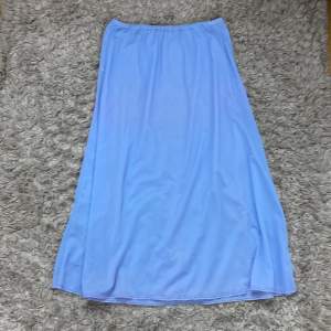 Perfekt blå tunn kjol till sommaren. Den har en slits längst ner.