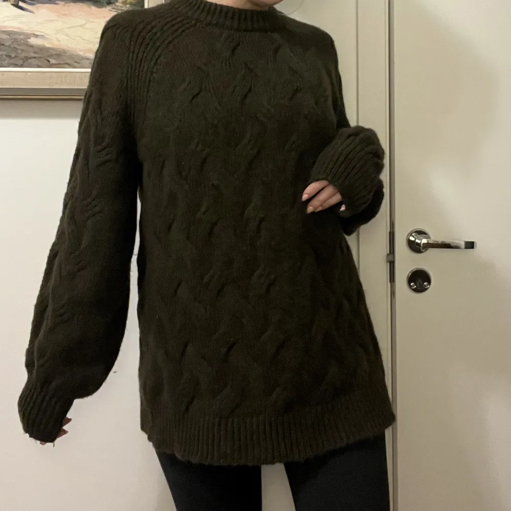 En mysig stickad tröja i färgen mossgrön. Modellen är lite längre och storleksmässigt lite större för att vara en xs. Använd ett fåtal gånger, nästan som ny i skick!. Neuleet.