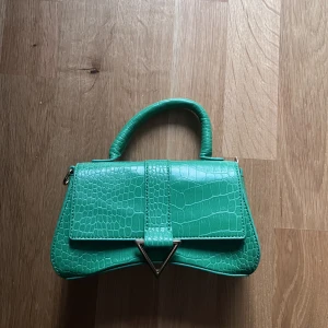 Grön Väska - grön mini väska inköpt från ASOS. aldrig använd. fint skick
