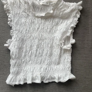 Topp - Vit topp med volang och resordetaljer