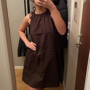 Brun klänning  - Säljer en brun klänning från hm som aldrig kommit till användning, fin att ha som strandklänning eller liknande!! Kontakta mig om du har frågor 🥰 Köparen står för frakt