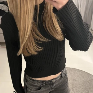 Svart stickad tröja - En helt oanvänd svart stickad tröja från NAKD med lite vaderade axlar. Tight men funkar även som storlek S. Ordinarie pris 550