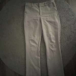 Gråa kostymbyxor - Storlek 42, mid waist Bra skick, använda 3-4 gånger.  Sitter super bra på. Köpta för 499kr.