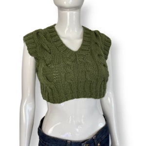 Kabelstickad  - Kort stickad topp. Åker upp om man sträcker på armarna så tipsar att ha en topp under. MÅTT: Armhåla till armhåla 40cm & längd 31cm.  