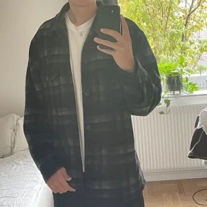 Jacka - En vår jacka från Uniqlo. Mörka färger och går mot mörkblått/svart. Jag är 187 cm storlek Large