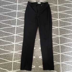 Kostymbyxor NAKD - Säljer dessa fina kostymbyxor från NAKD x REBORN kollektionen. I använt skick därav noppriga. Slitsen vid fötterna gör att de lägger sig fint vid skorna.