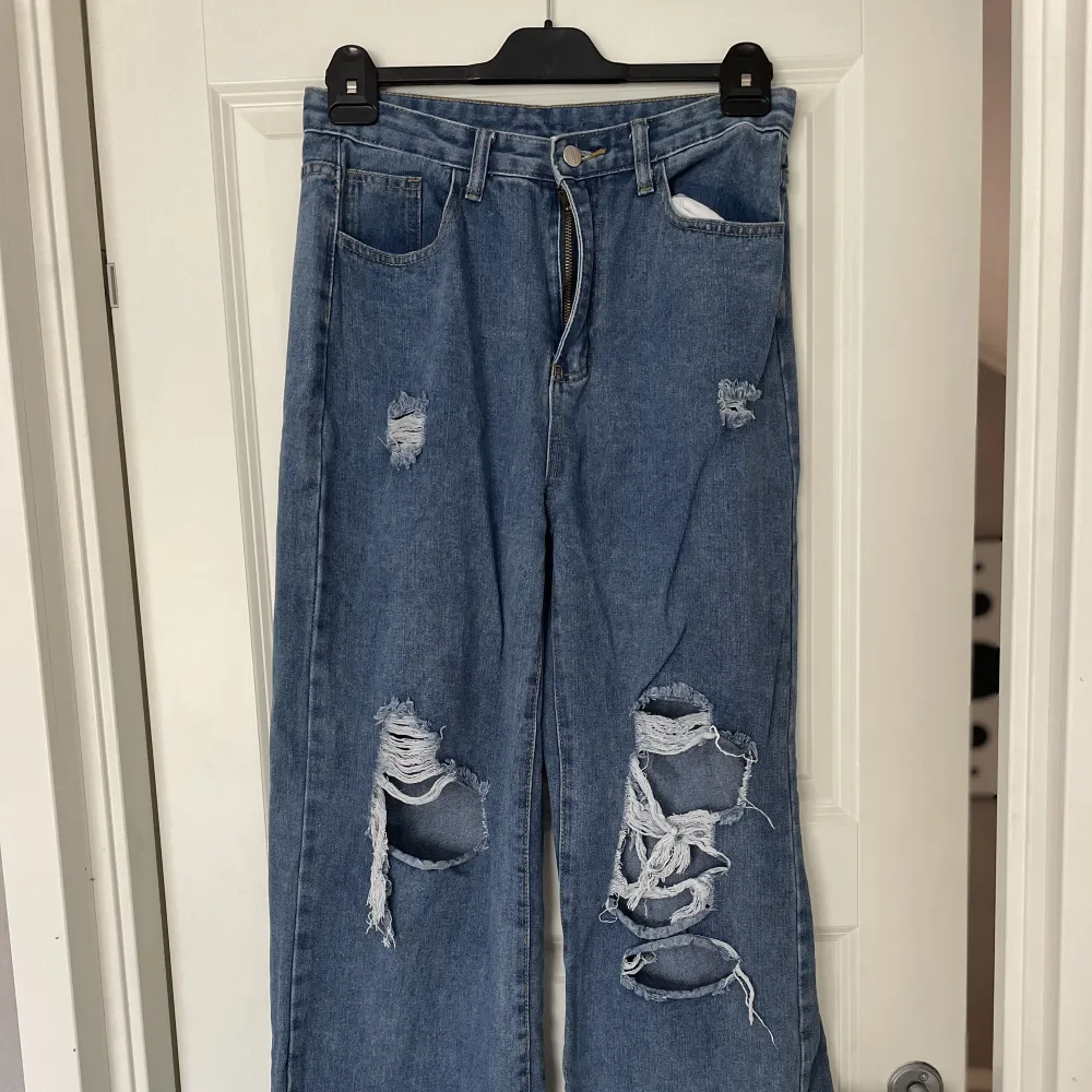 Mörkblå jeans med hål från H&M, använda men ingen skada skedd . Jeans & Byxor.