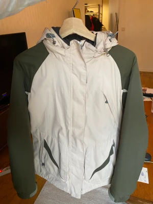 Winter/Ski Jacket  - The jacket is in good condition. Size 38 and it has pockets inside as well. The colors are a very light pink and olive green sleeves.