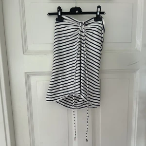 Halternecktopp - Vit och mörkblå randig halterneck topp som man själv knyter vid halsen i storlek L