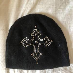 Cool plain beanie med ett kors av rhinestones. Helt oanvänd och i bra skick