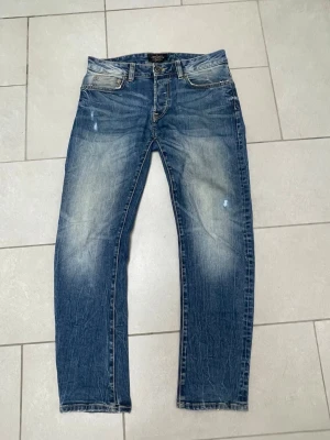 Dressman vintage jeans - Säljer dessa vintage dressman premium jeans med coola slitningar och sjuk fade. Storlek W32 L30 de är sydda i skrevet men inget som syns när man har på sig de.