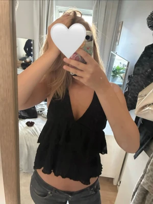 Jätte snygg volang topp - jätte snygg volang top! Är från Nelly i storlek L, men jag är storlek S/M och den sitter bra, men lite mer löst. Anledningen att lappen där bak är avklippt är så pga storleken så vände den på sig i bland och lappen stack ut🤍