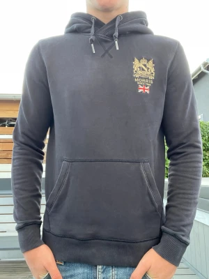 Morris hoodie, strl XS - Säljer en fin mörkblå hoodie i bra skick. Modellen på bilden är 178cm lång och väger ca 70kg.                                                                     Storlek: XS                                                                           Tröjan skickas inom 24h efter köp. Hör av er vid funderingar!