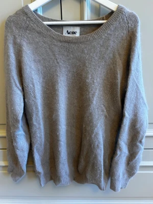 Beautiful Acne Studios oversized knit sweater in a soft brown/taupe shade 🤎 - Beautiful Acne Studios oversized knit sweater in a soft brown/taupe shade. 🤎 The relaxed oversized silhouette, wide neckline and subtle knitted detailing make it the perfect cozy sweater while still looking chic and put-together.
