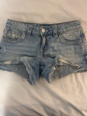 Ett blå par shorts med fina detaljer på fickorna från Gina tricot - Super gullig och somrig blå kjol från Stina tricot med jätte fina detaljer på fickorna. Perfekt till sommaren och passar med allt. Storleken funkar som en XXS