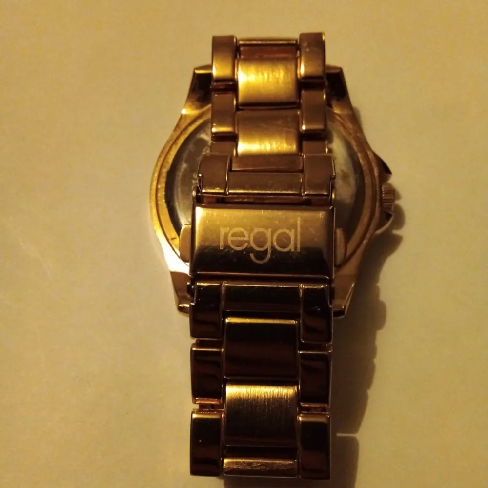 Snygg & Elegant analogklocka från Regal. Damklocka i mycket fint skick, är nästan aldrig använd. Legat fint förvarad och i princip fortfarande som ny. Klockan är Guldfärgad med vackra dekorativa stenar av Swarovski. ONESIZE men är justerbar. Fås i en fin presentask. 🛍️🎁 Nytt batteri ingår. Fler bilder kan skickas vid intresse. Ordinariepris, 449:- . Asusteet.