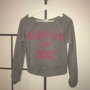 Grey long sleeved shirt  - Please do not ask me what the text says cause I don't know myself lol. The neck part of the shirt is very long.  