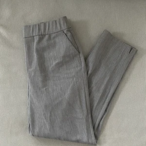 Ljusgrå kostymbyxor från Zara - Ljusgrå kostymbyxor från Zara, strl XS med liten slits nertill. Resår i midjan. Kan skickas spårbart med postnord mot fraktkostnad🥰