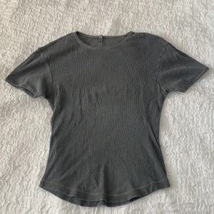 Grå tröja  - Grå tröja som är lite figursydd. Står att den är L men skulle säga mer M, den är stretchig dock. 