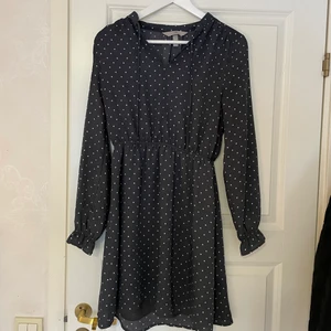 Klänning hm  - Söt prickig klänning från hm. Finns två tunna snören fram som man kan knyta en liten rosett med. Resår i midjan. Går till mitten av låret på mig som är 173 cm. 