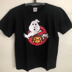 Bape / Baby Milo x Ghostbusters Tee - Women’s Vintage Bape / Baby Milo x Ghostbusters T-Shirt  Size small, women’s fit.  Great condition, no flaws or damage.  DM if you need exact size measurements.   Buyer pays for all shipping costs. All items sent with tracking number.   No swaps, no trades, no offers. 