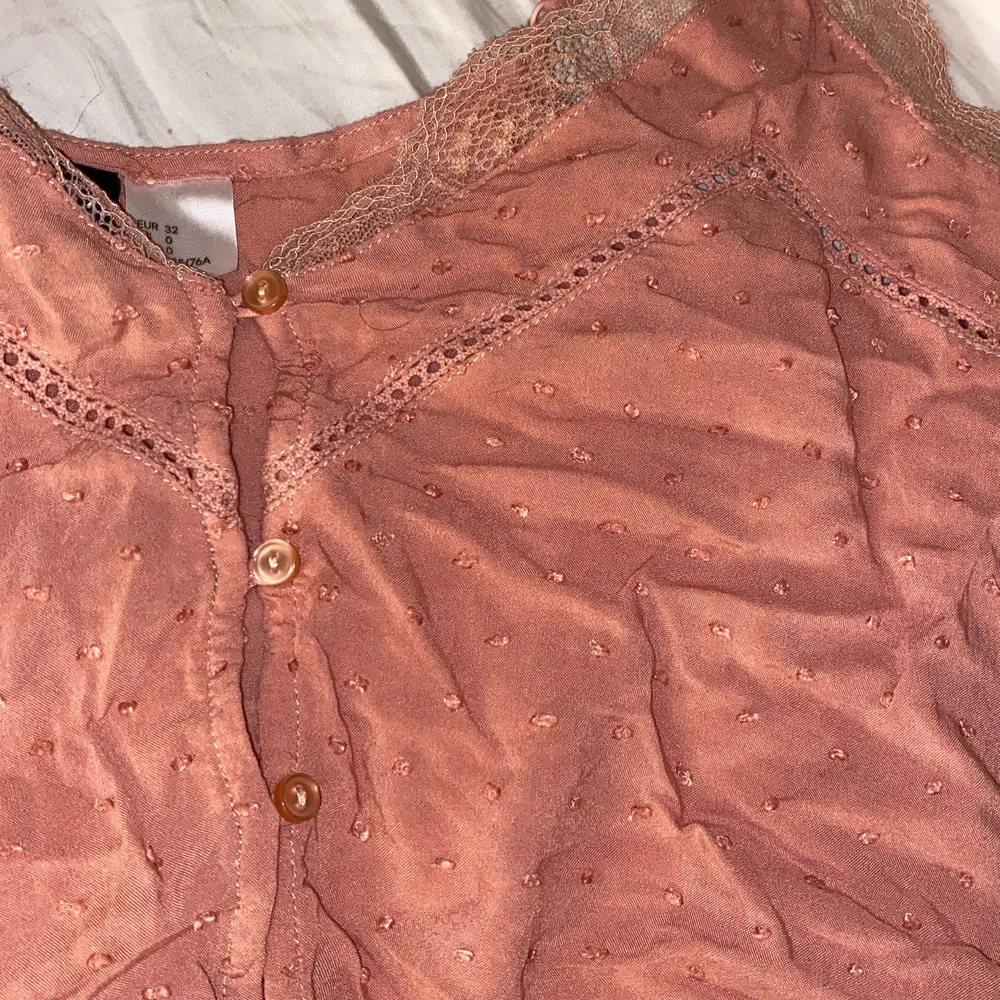 Ett smuts rosa linne från H&M i strl 32, lite spets har den och den är super gullig. Ganska använd . Toppar.