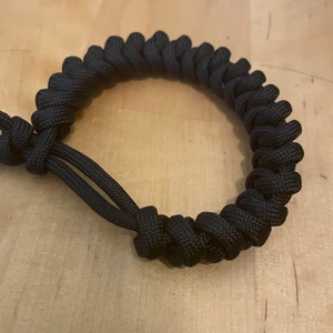 Paracord bracelet ( black) - Those bracelets are made of USA paracord which is a very durable material. 1- year warranty. 