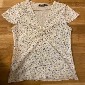 Blommig blus  - Säljer en blommig blus med tunt, stretchigt material som sluter sig kring kroppen. V-ringning och sparsamt använd. ✨