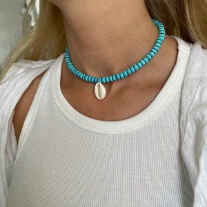 Handgjort halsband i blått - Superfint handgjort halsband i en blå kombination med snäcka fram. Försluts bak med lås och tre ringöglor för justering. 💙💙🌊🐠🐚🐳 Skapat fem st! ENDAST ETT KVAR